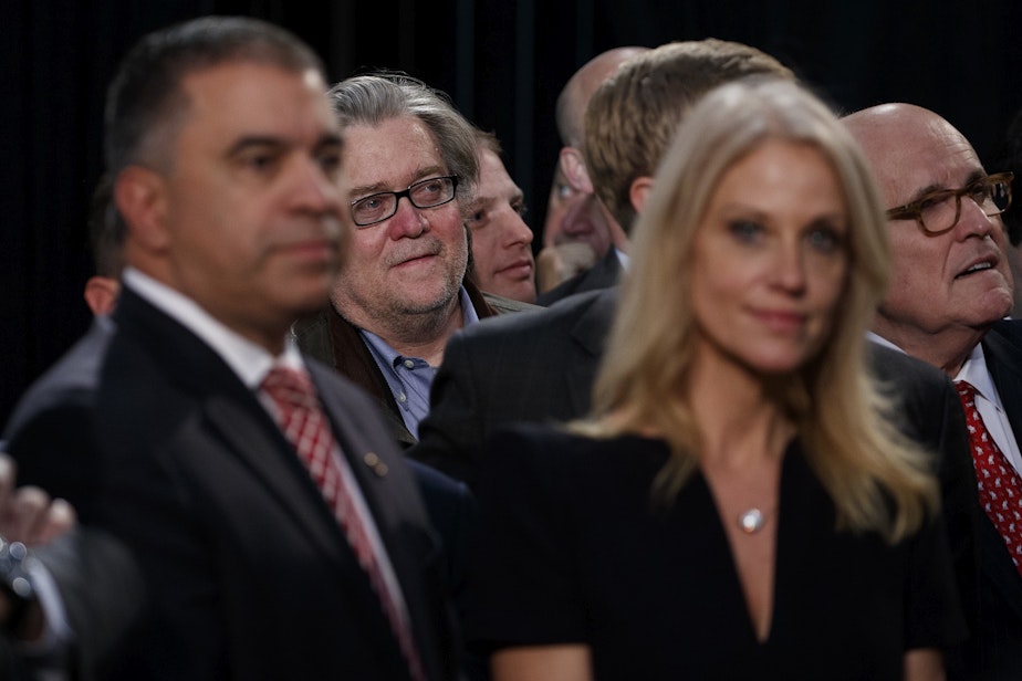 caption: Stephen Bannon, center left, back, campaign CEO for Republican presidential candidate Donald Trump, looks on as Trump speaks during a campaign rally on Election Day.
