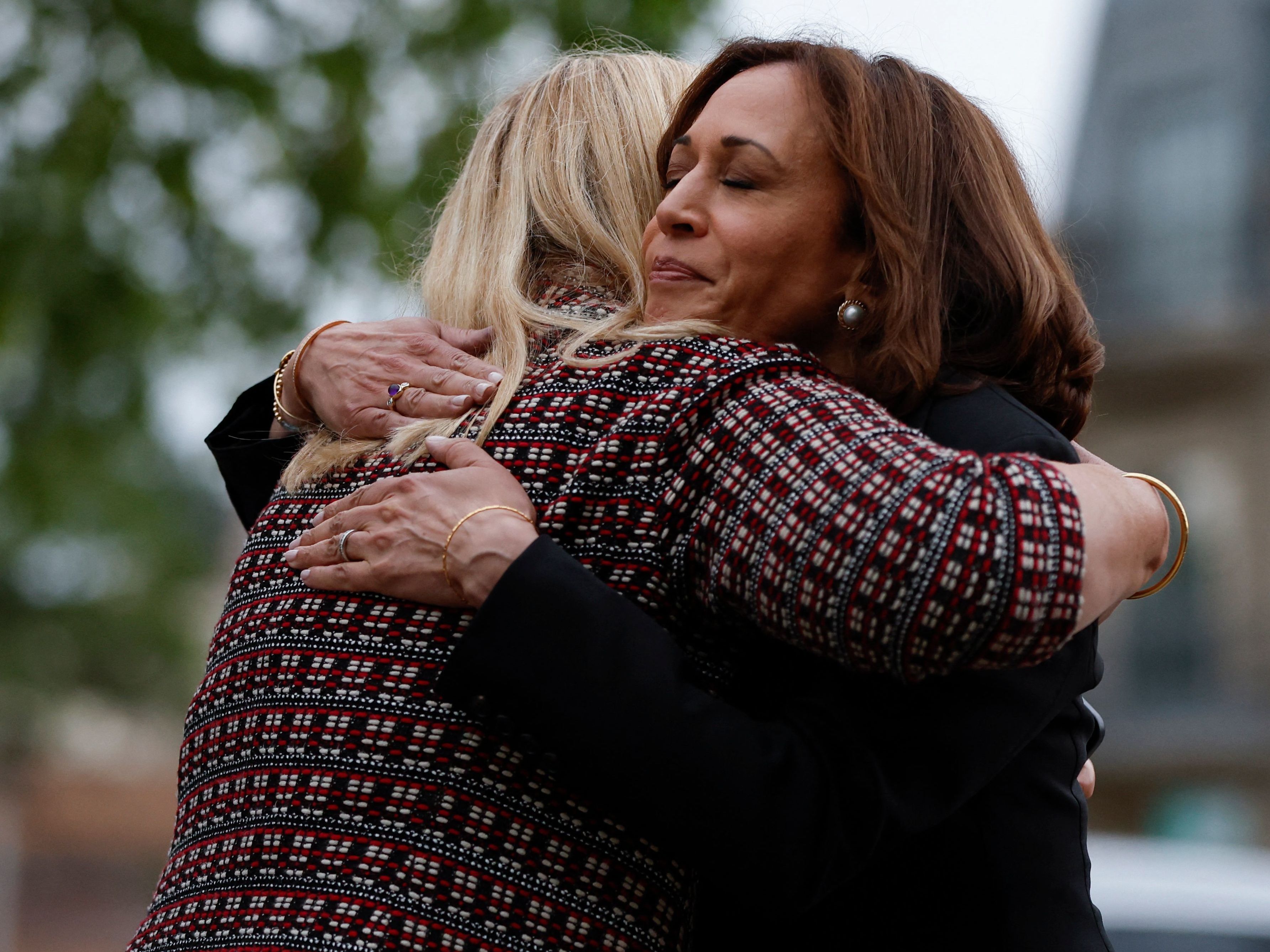 caption: Vice President Kamala Harris hugs Highland Park, Ill., Mayor Nancy Rotering on Tuesday as she visits the site of a shooting Monday that killed seven people.