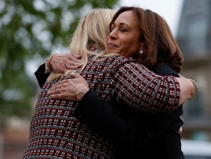 caption: Vice President Kamala Harris hugs Highland Park, Ill., Mayor Nancy Rotering on Tuesday as she visits the site of a shooting Monday that killed seven people.