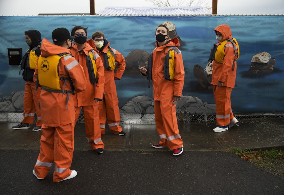 caption: Maritime High School students wait outside of Sr3, the Sealife Response, Rehabilitation and Research center, before a tour on Thursday, September 30, 2021, in Des Moines. 
