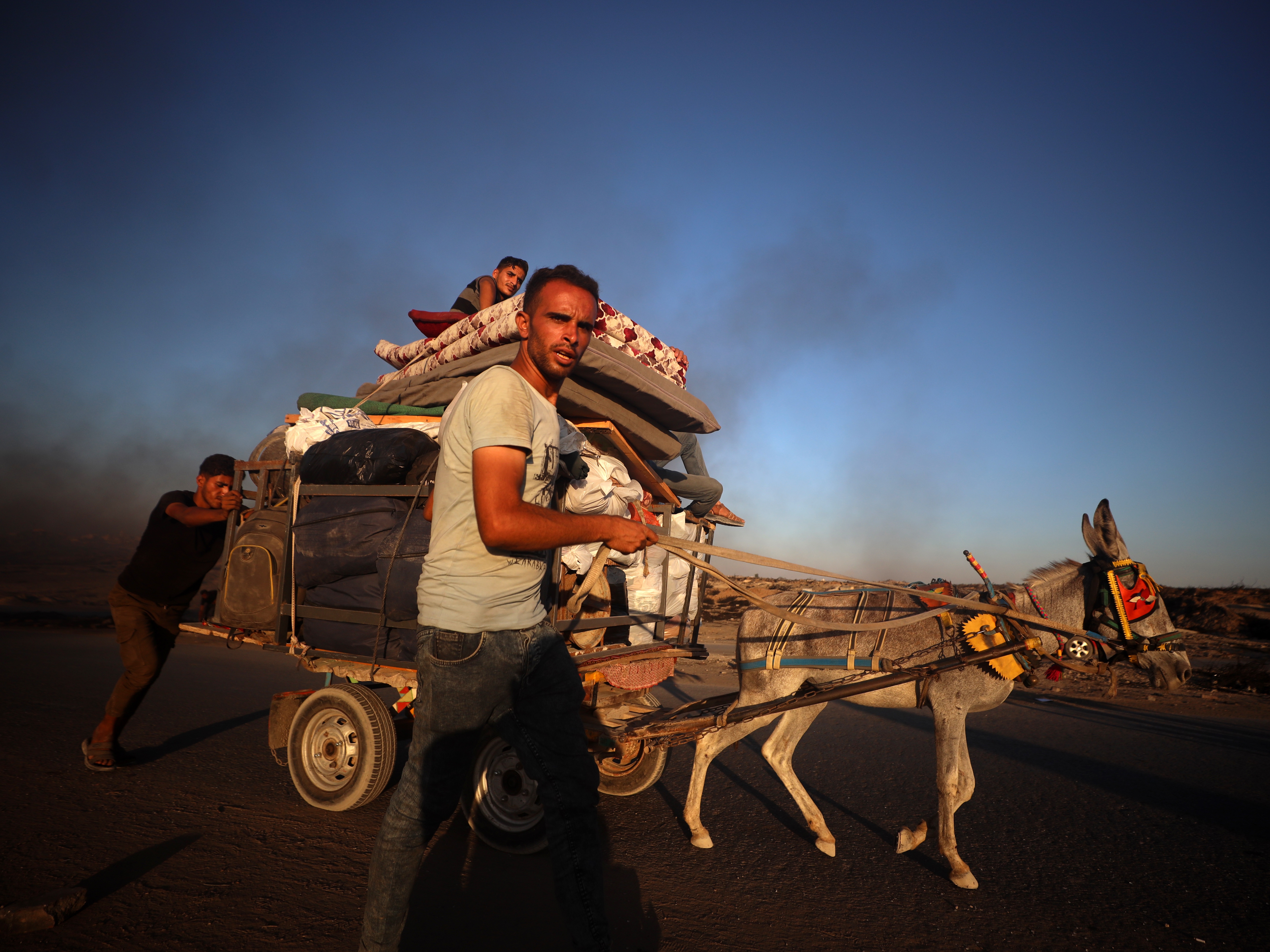 caption: Displaced Palestinians fleeing the northern Gaza Strip move with their belongings along the Sea Road in Gaza City, Palestine, on September 1, 2025.