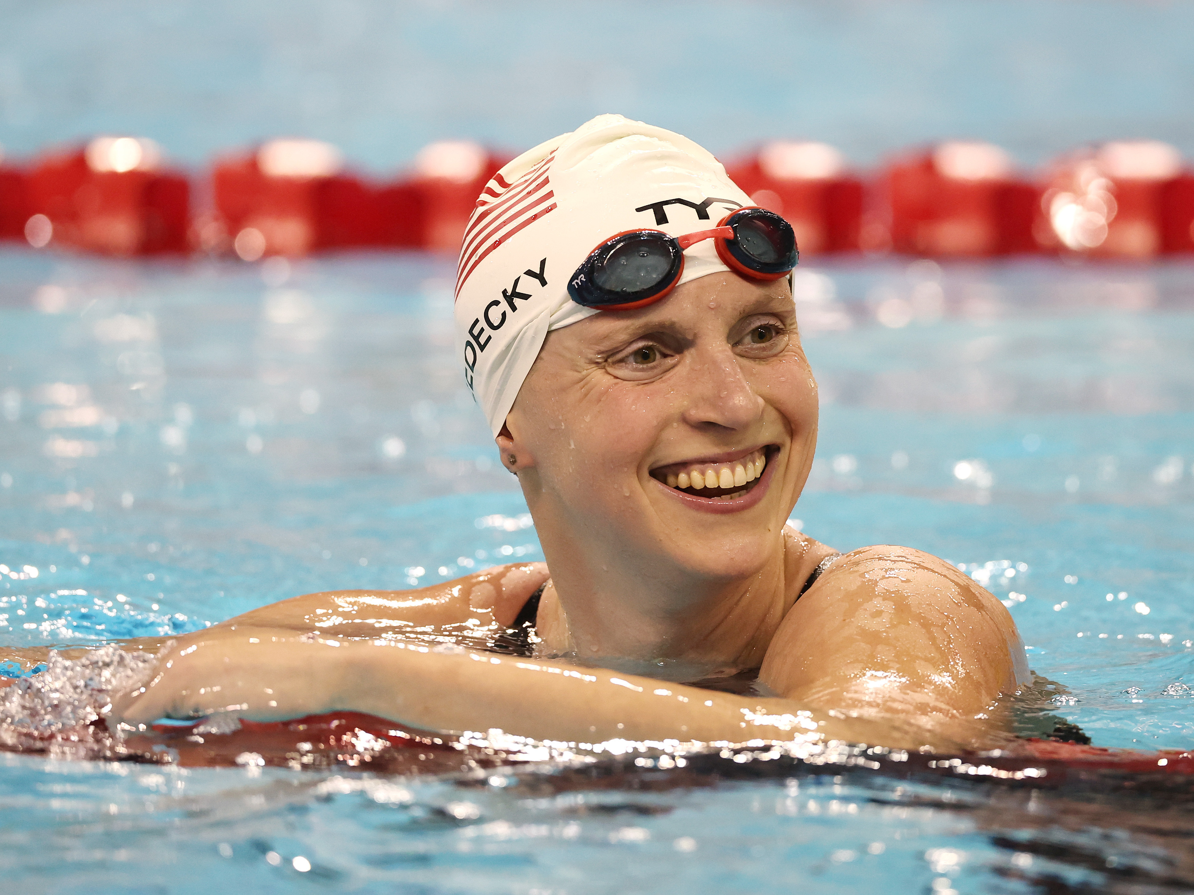 caption: Katie Ledecky reacts after setting a world record and winning the Woman's 1500m Final at the FINA Swimming World Cup in 2022.