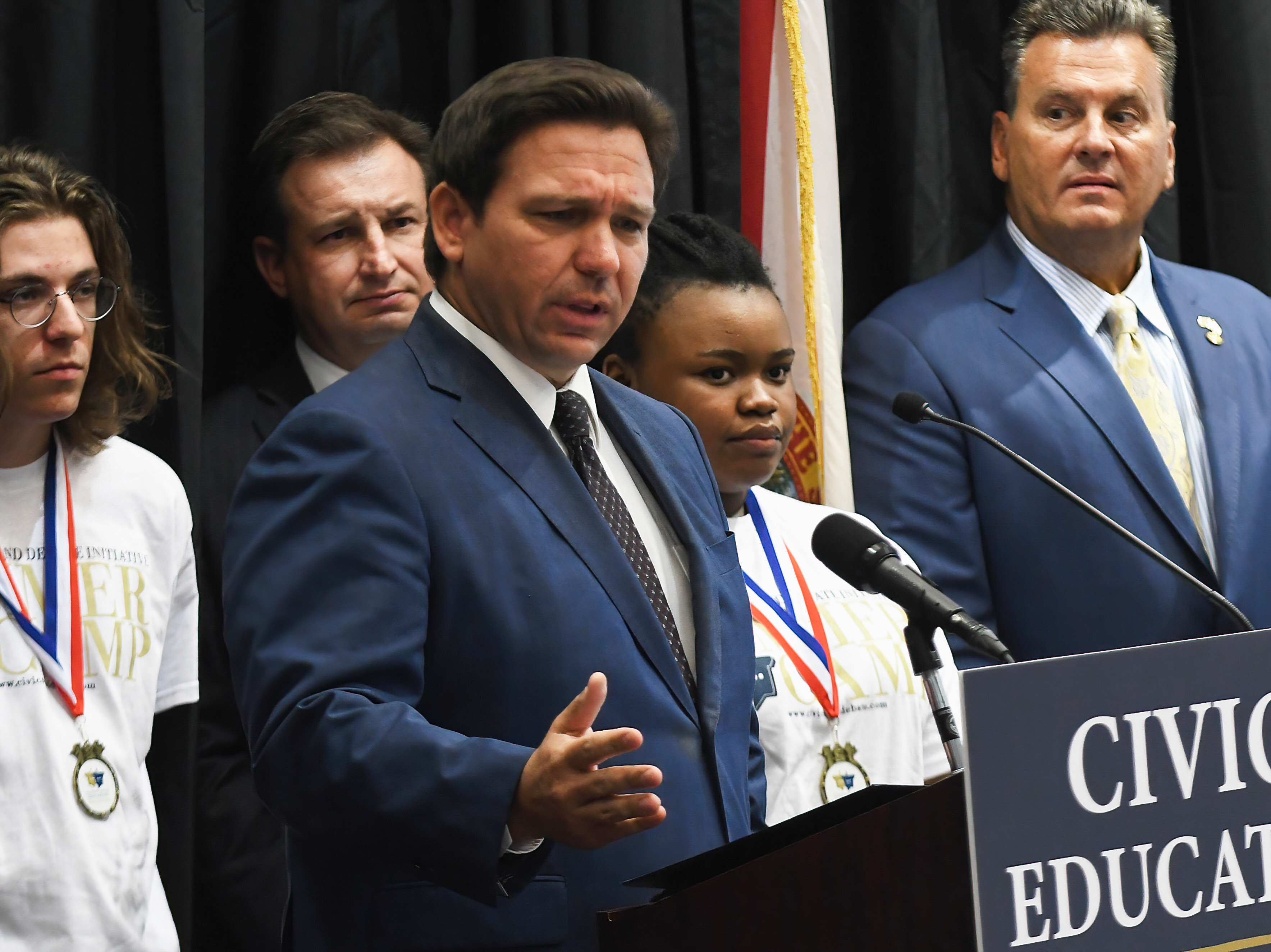 caption: Florida Gov. Ron DeSantis speaks at a news conference at Crooms Academy of Information Technology in Sanford to discuss Florida's civics education initiative of unbiased history teachings.