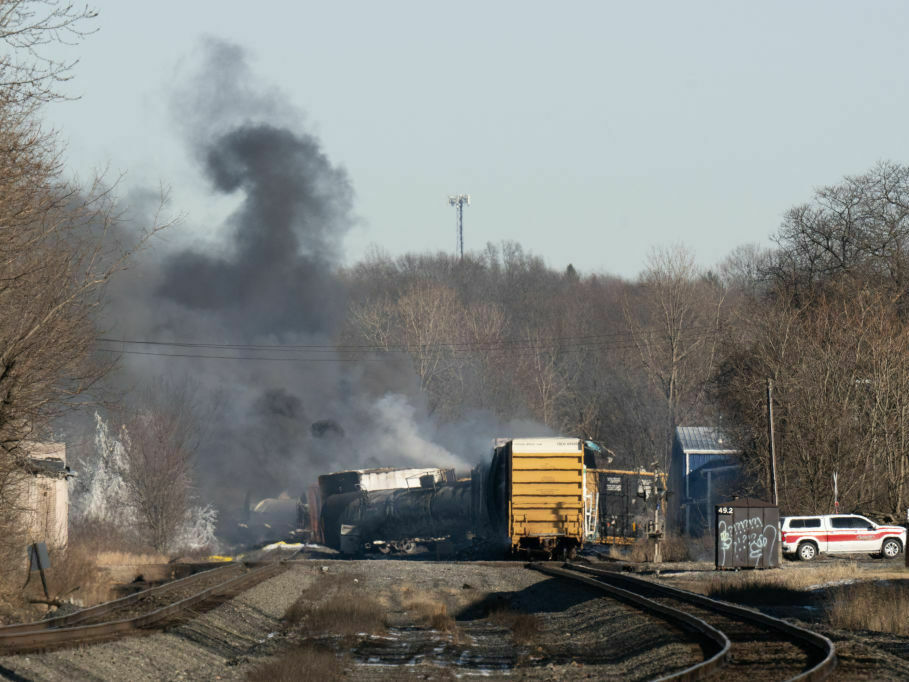 caption: Smoke rises from a derailed cargo train in East Palestine, Ohio, in February of 2023.