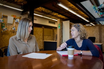 caption: Stacey Marron (on right), domestic violence program manager at Broadview Shelter and Transitional Housing, meets with Kelsey Fleetwood, a legal advocate, at Solid Ground’s main headquarters in Seattle. Broadview is Seattle’s only remaining domestic violence shelter where a person with children can call directly seeking shelter without a referral. 