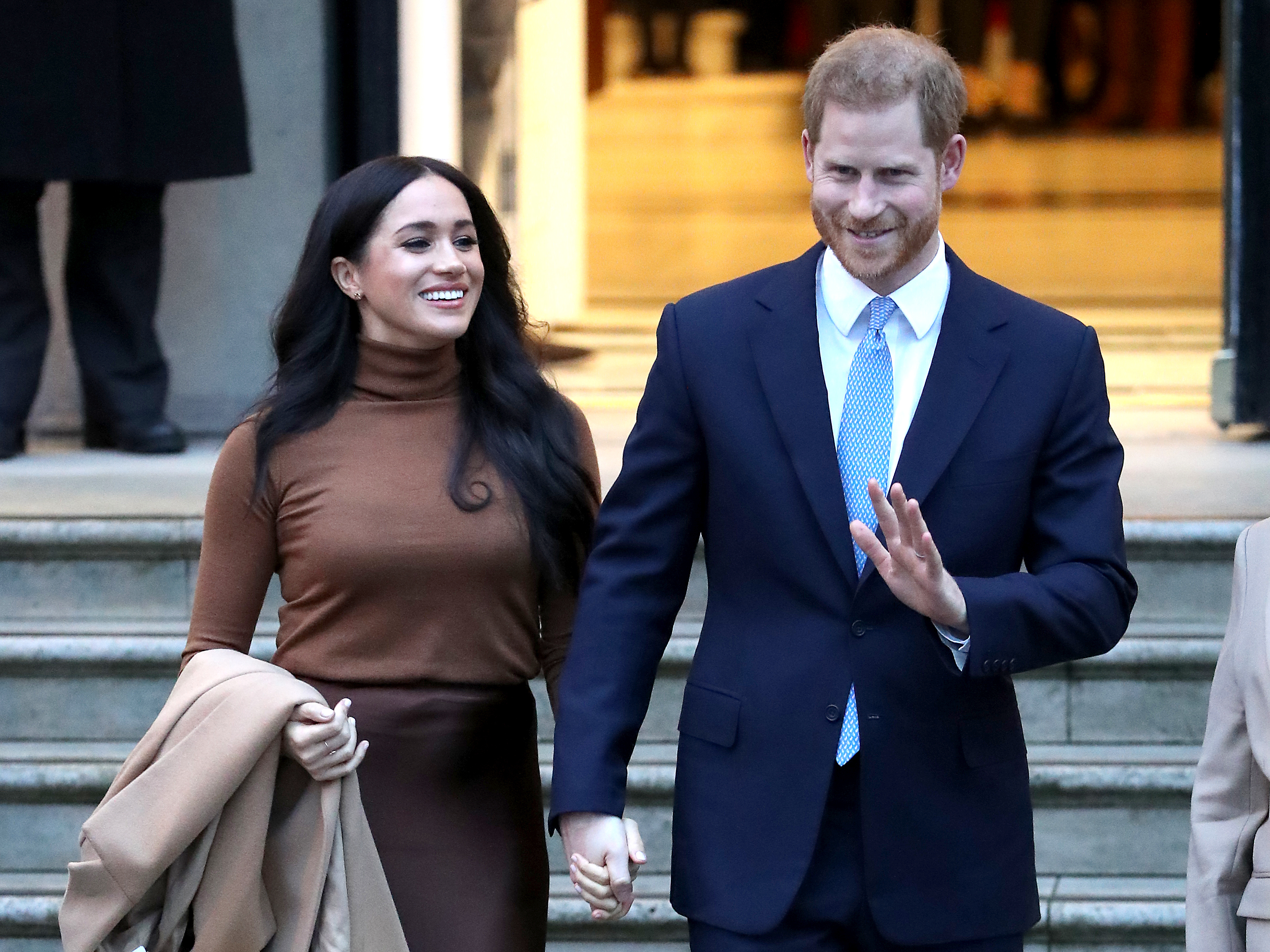 caption: The duke and duchess of Sussex, also known as Prince Harry and Meghan Markle, have announced that they will step back from certain royal duties. The couple is seen here on Tuesday in London.