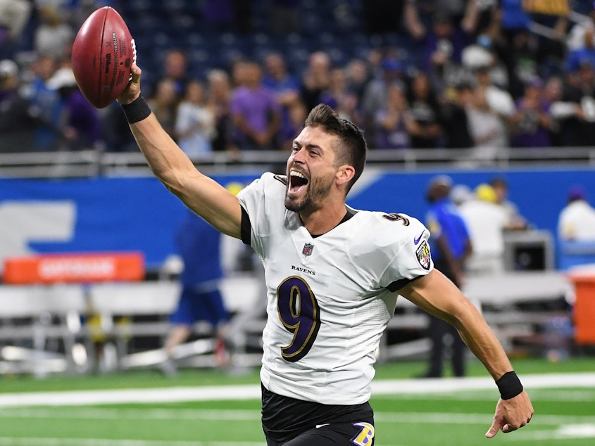 caption: Justin Tucker celebrates after kicking a game-winning field goal from a record 66 yards, giving the Baltimore Ravens a win over the Detroit Lions at Ford Field in Michigan.