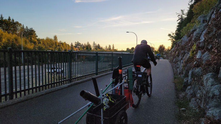 caption: Lee Zuhars pedals home on the 520 bike path on Wednesday, Sept. 13, 2023.