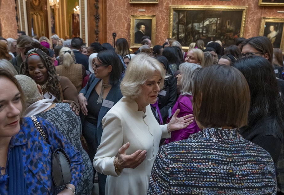 caption: Charity leader Ngozi Fulani (center left) attends a reception held by Britain's Camilla, the queen consort, (center) to raise awareness of violence against women and girls in Buckingham Palace in London on Tuesday.