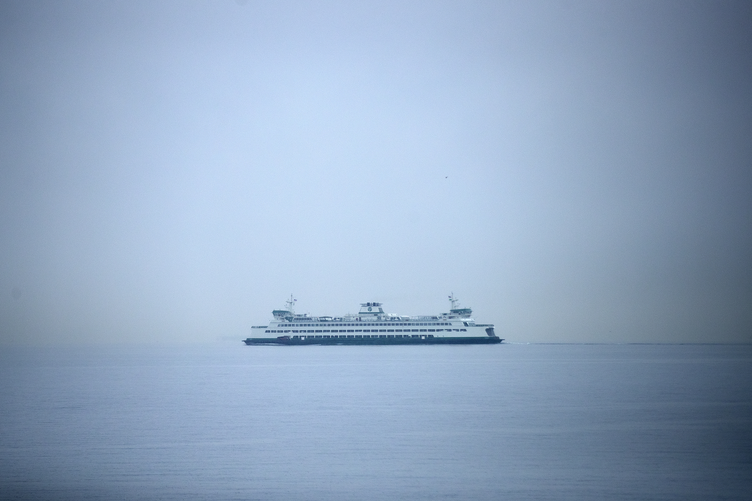 caption: A Washington state ferry is seen from Alki Beach as snow falls on Friday, March 13, 2026, in West Seattle.