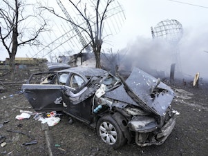 caption: Damaged radar, a vehicle and equipment are seen at a Ukrainian military facility outside Mariupol.