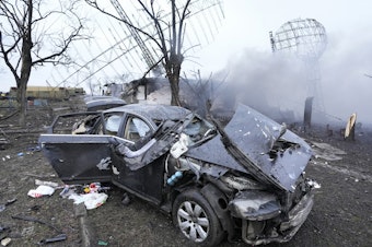 caption: Damaged radar, a vehicle and equipment are seen at a Ukrainian military facility outside Mariupol.
