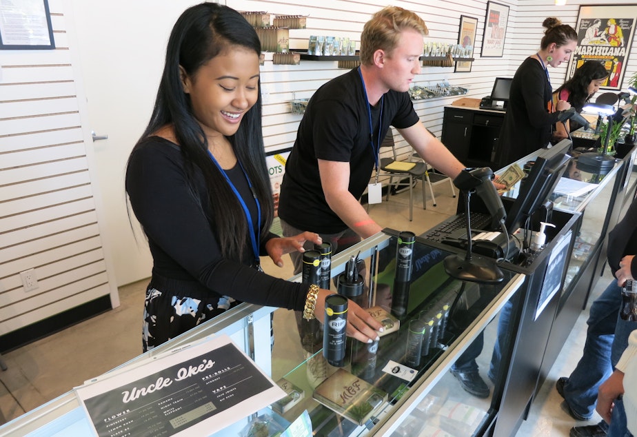 caption: Employees at Ike's Pot Shop in Seattle's Central District sell marijuana products on their opening day, Sept. 30, 2014.