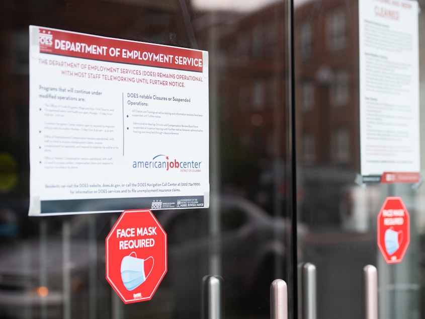 caption: Signs are displayed outside the Washington, D.C. Department of Employment Services. New claims for unemployment benefits around the country rose for the first time in four months.