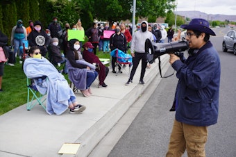 caption: Northwest Justice Project Attorney David Morales addresses striking Matson Fruit workers on May 13 to inform them of labor rights and ask for testimonies of working conditions on the production line.