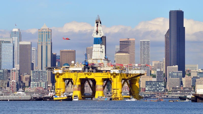 caption: Foss Maritime tugs pull the Polar Pioneer past downtown Seattle on the way to Terminal 5 on Thursday, May 14, 2015.
