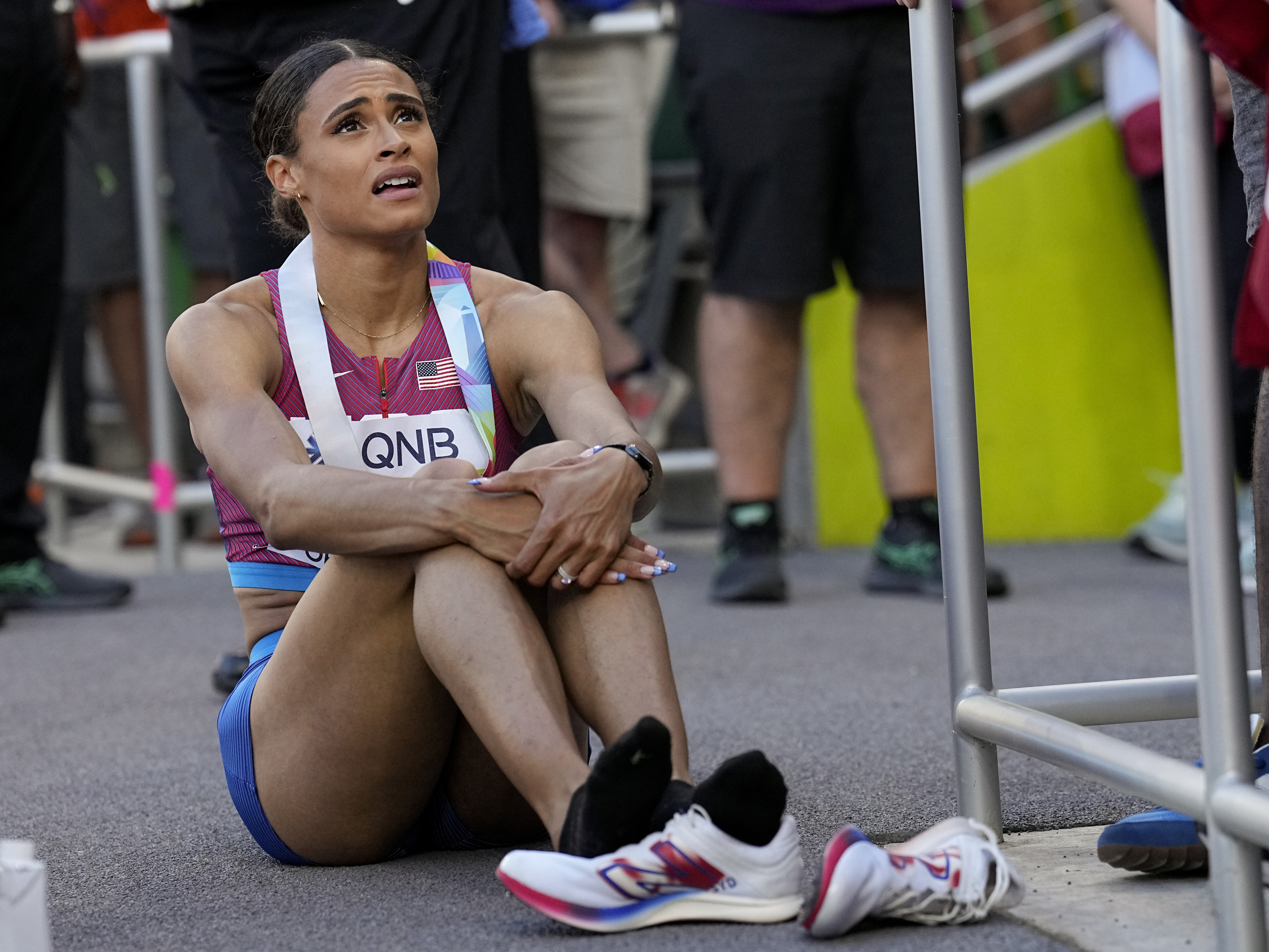 caption: Sydney Mclaughlin, of the United States, recovers after winning the final of the women's 400-meter hurdles at the World Athletics Championships on Friday.
