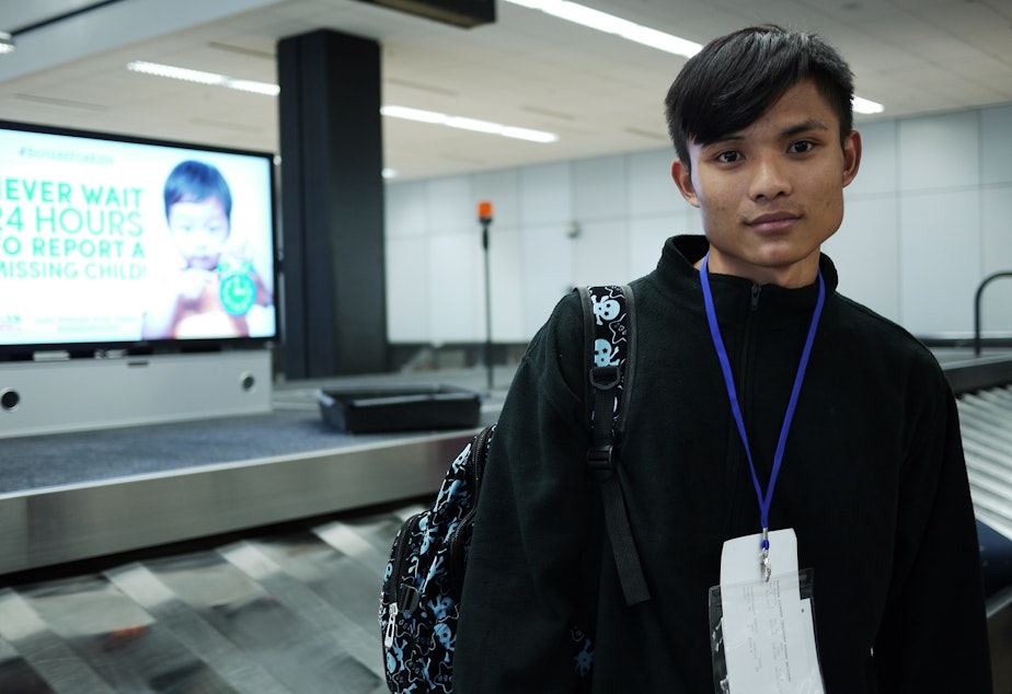 caption: Tu Tu at SeaTac Airport on his first day in America. He didn&apos;t want to leave, but his father encouraged him to go. His dream is to learn English.