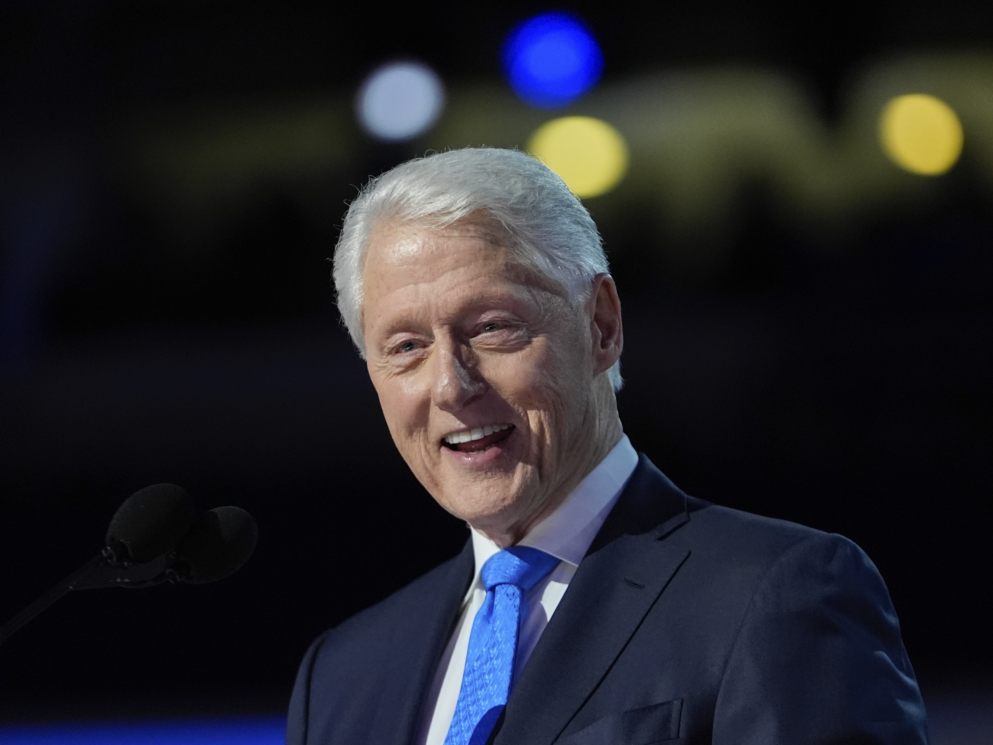 caption: Former President Bill Clinton speaks during the Democratic National Convention on Aug. 21 in Chicago.