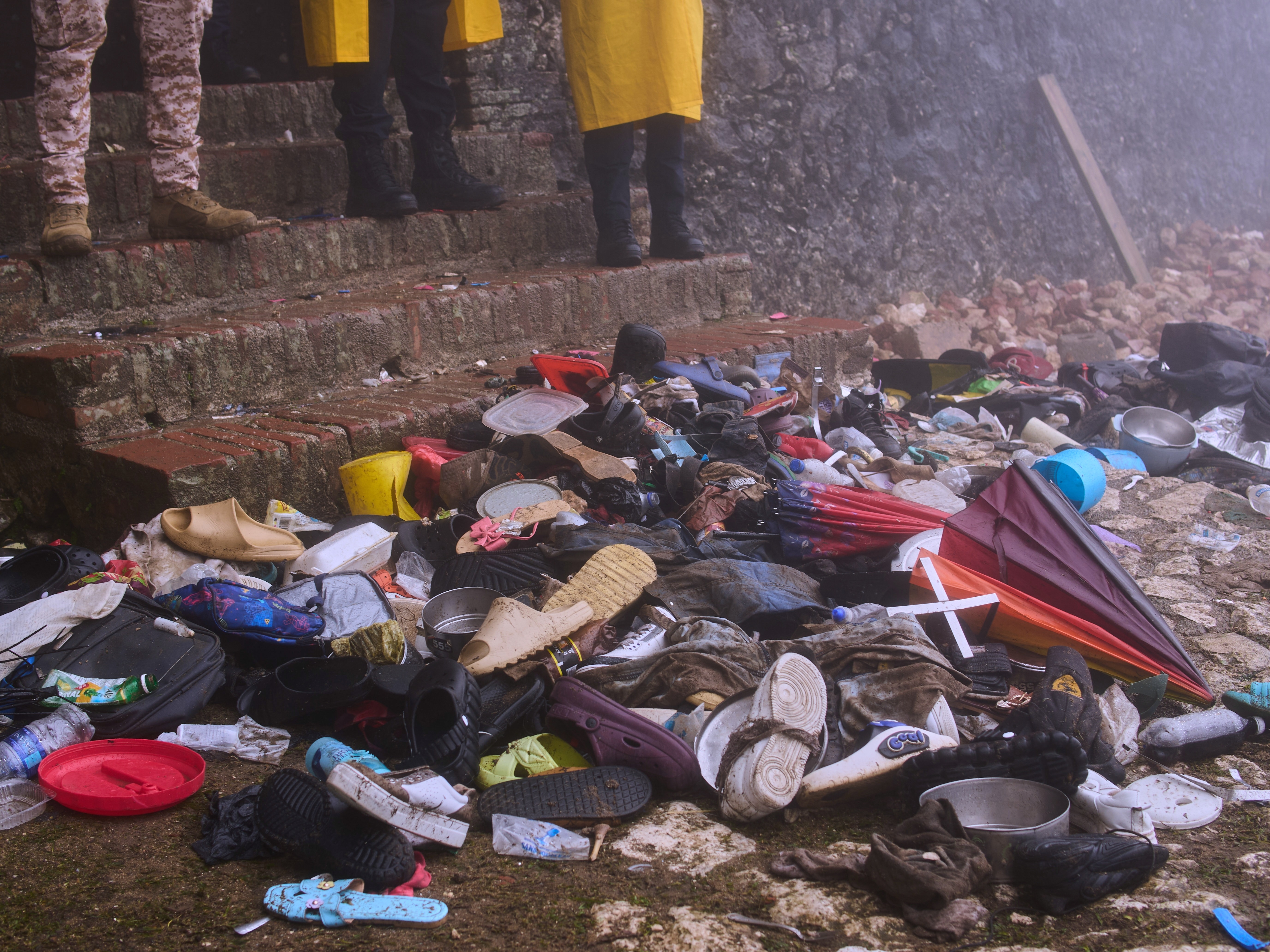 caption: The shoes of victims of a deadly stampede sit by the main entrance of the Citadelle Laferriere in Milot, Haiti, Sunday, April 12, 2026.