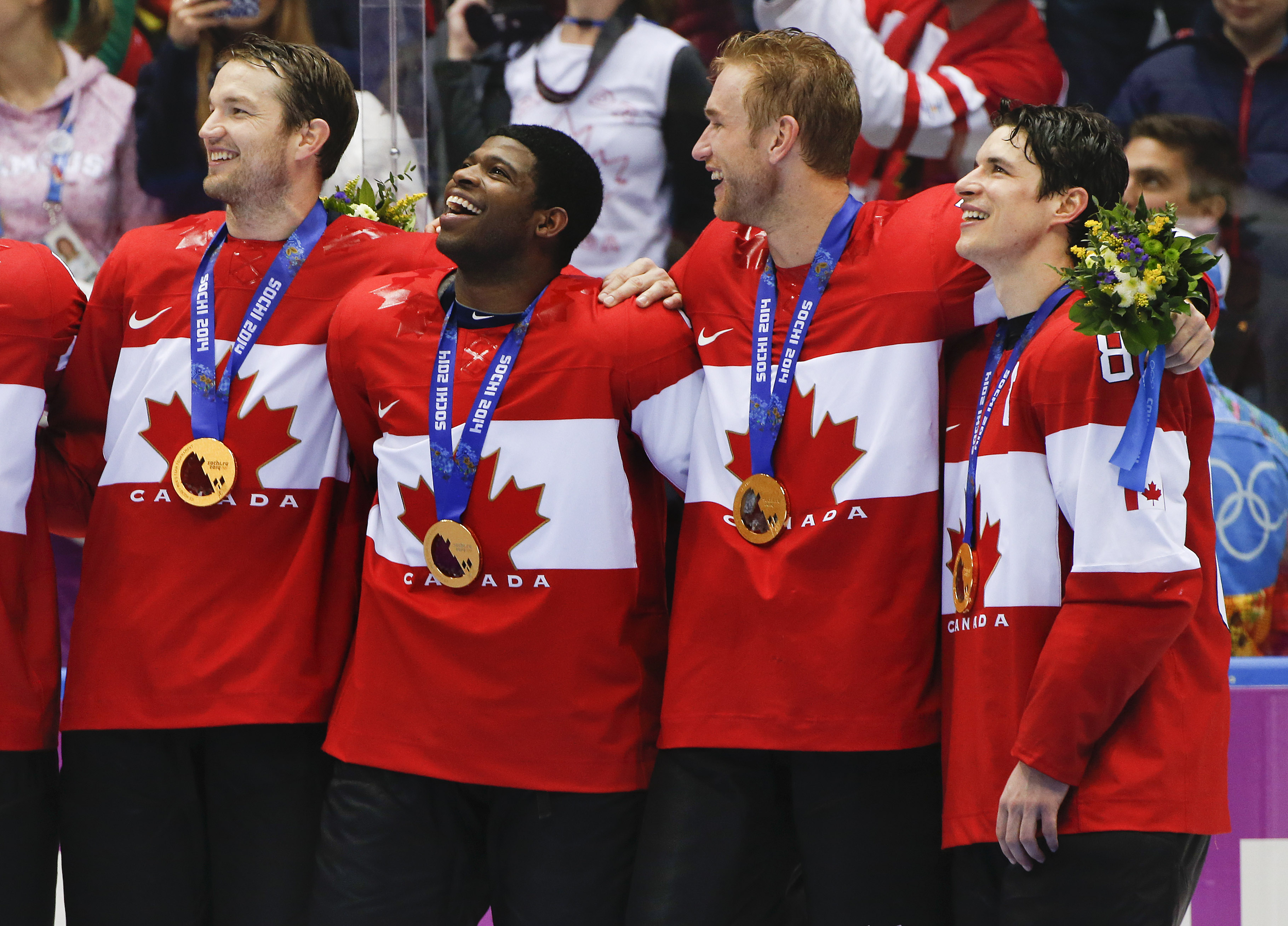 caption: Canada forward Sidney Crosby, far right, stands with teammates for the Canadian national anthem after beating Sweden 3-0 in the men's gold medal ice hockey game at the 2014 Winter Olympics, Sunday, Feb. 23, 2014, in Sochi, Russia.