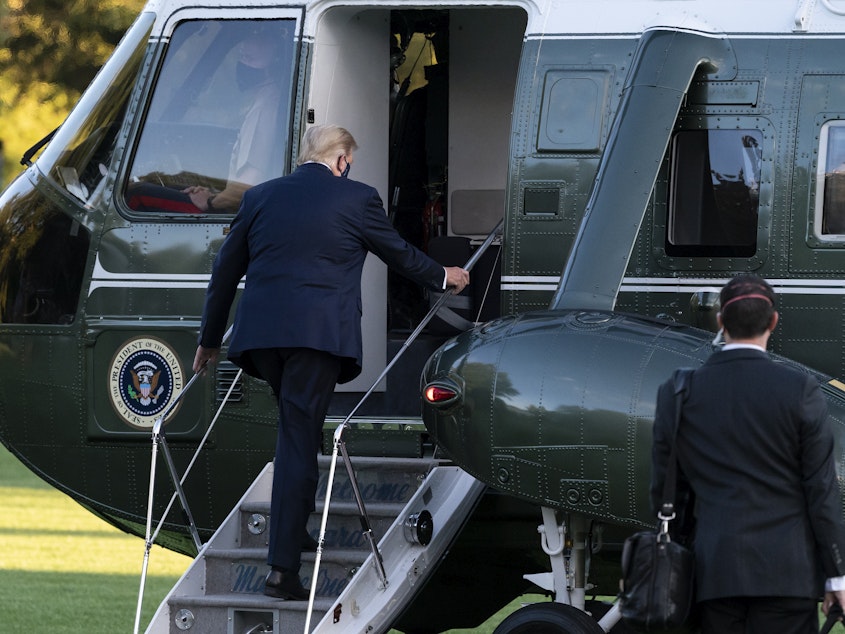 caption: President Trump boards Marine One for a trip from the White House to Walter Reed National Military Medical Center for COVID-19 treatment in early October. Trump received Regeneron's antibody cocktail during his illness.