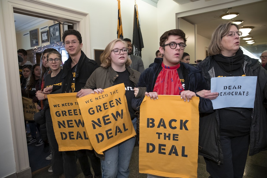 caption: Environmental activists occupy the office of Rep. Steny Hoyer, D-Md., the incoming majority leader, as they try to pressure Democratic support for a sweeping agenda to fight climate change, on Capitol Hill in Washington, Monday, Dec. 10, 2018. (J. Scott Applewhite/AP)