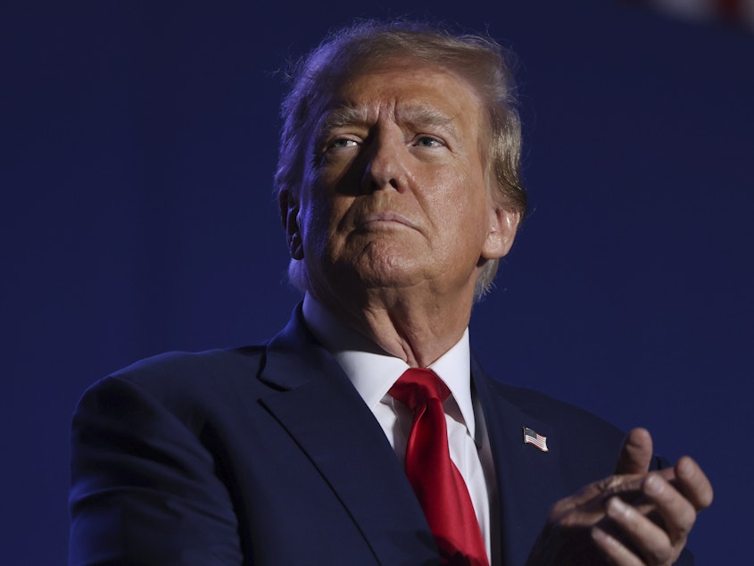 caption: Former President Donald Trump speaks at a campaign rally on Dec. 16 in Durham, N.H.