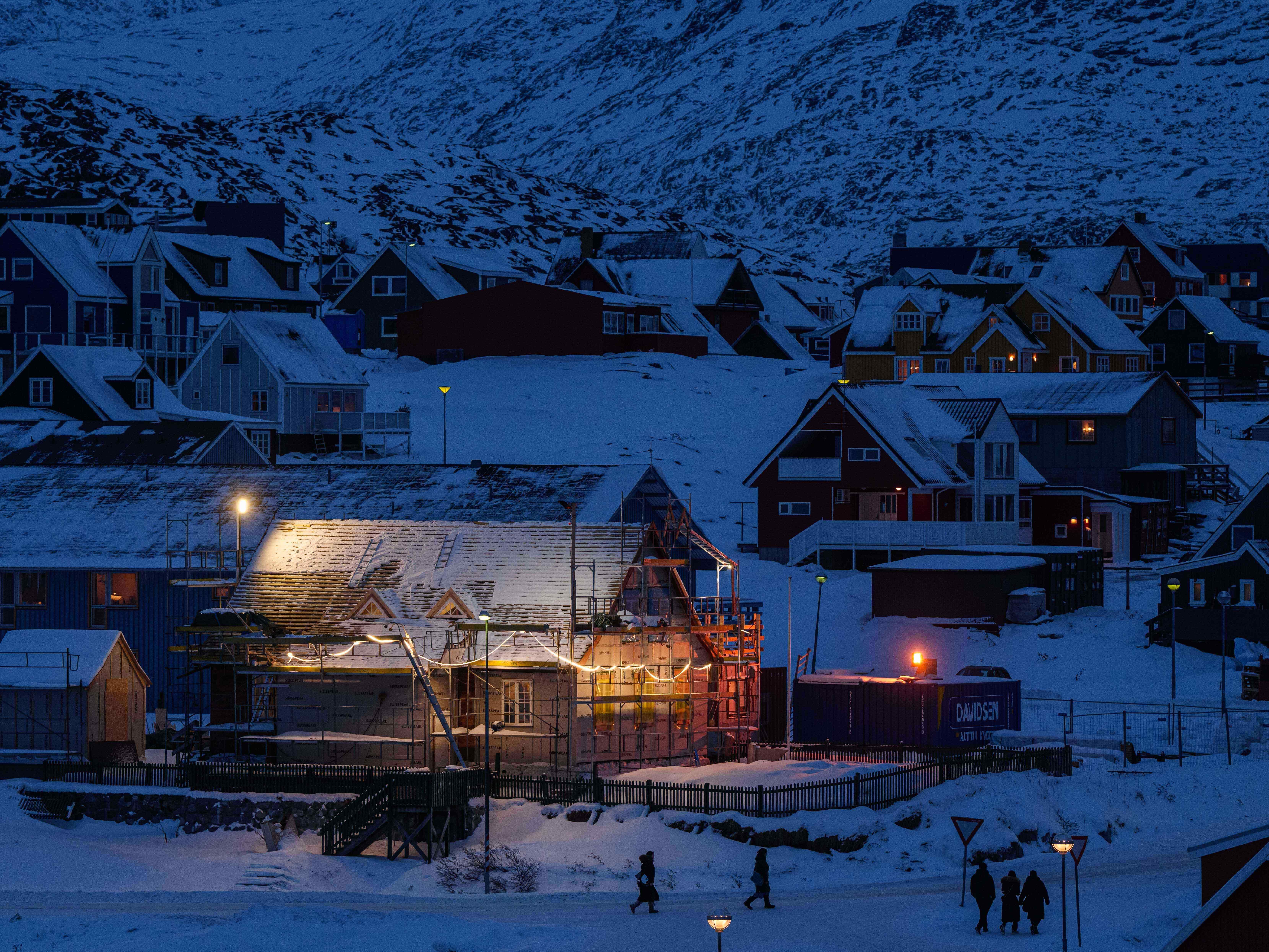 caption: People walk along a street in downtown of Nuuk, Greenland, on Tuesday, Jan. 13, 2026.