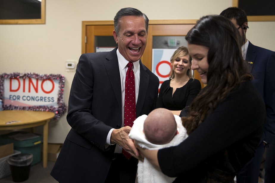 caption: Candidate Dino Rossi smiles at his 7-week-old granddaughter, Adaline Grace Conklin, while standing with his daughter, Juliauna Conklin, on Tuesday, November 6, 2018, at his campaign headquarters in Issaquah. 