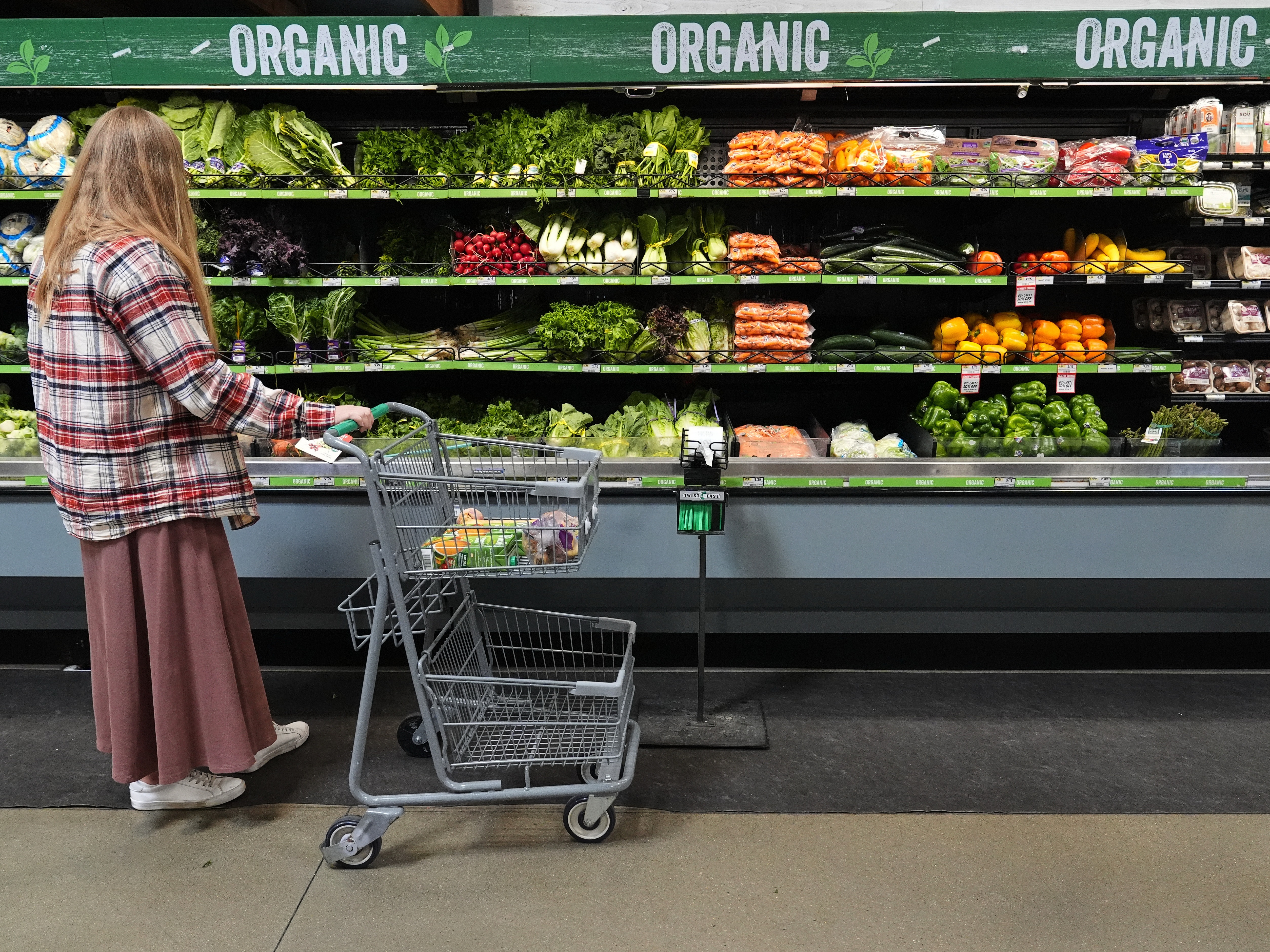 caption: A person shops for produce, which is covered by the USDA Supplemental Nutrition Assistance Program (SNAP), at a grocery store Monday in Baltimore.