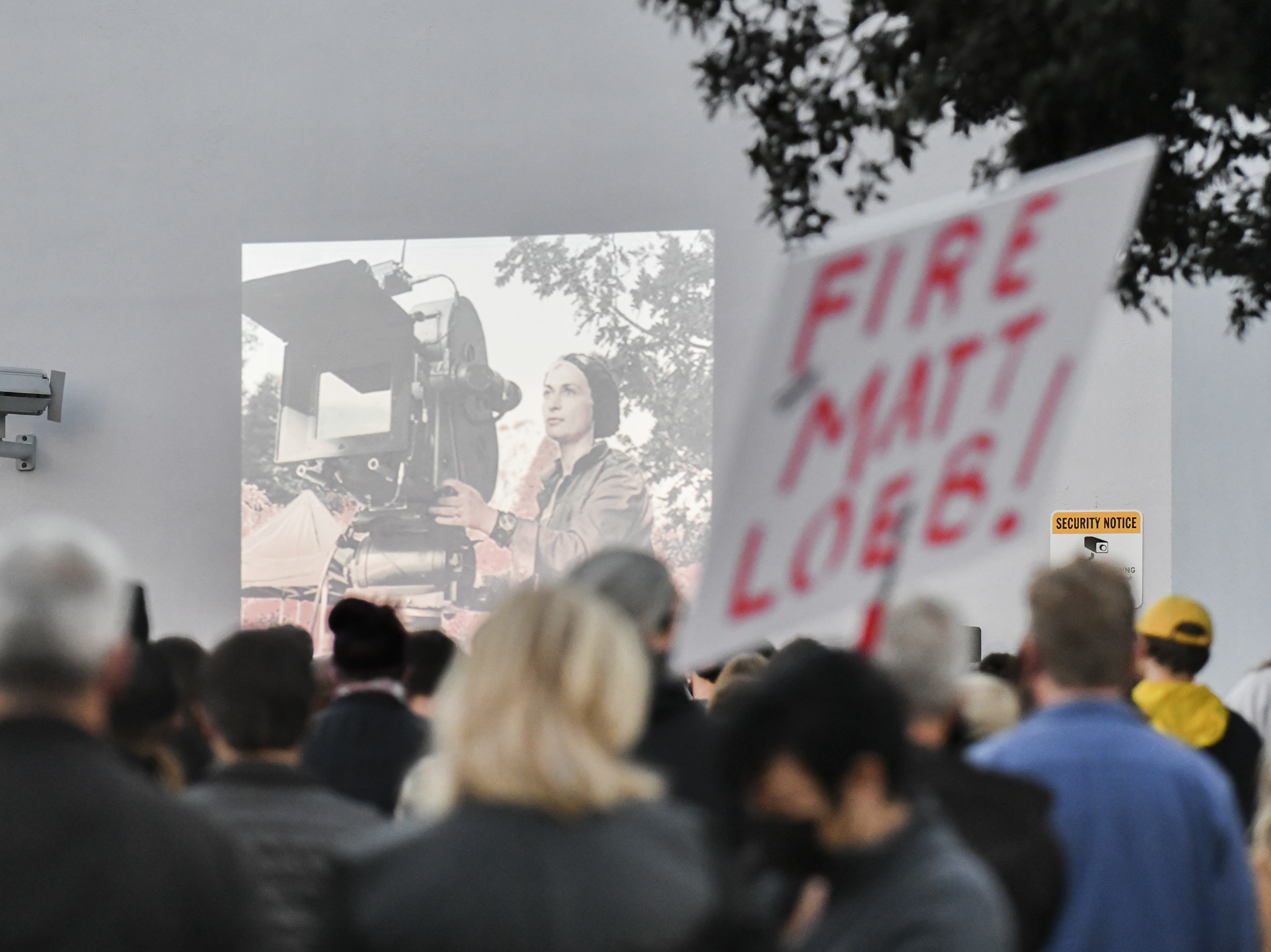 caption: A candlelight vigil is held for Halyna Hutchins at a California IATSE office. Members of the International Alliance of Theatrical Stage Employees union have been pushing for better hours, citing safety concerns, after Hutchins was killed on set.