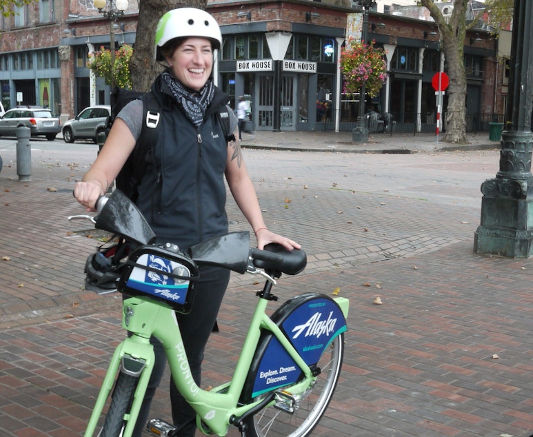 caption: Holly Houser, Pronto's Executive Director, demonstrates Seattle's new bicycle share program.