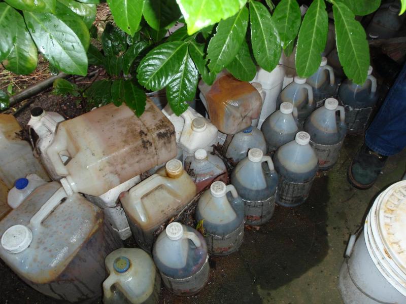 caption: Containers were found inside and outside the house.