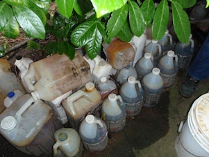 caption: Containers were found inside and outside the house.