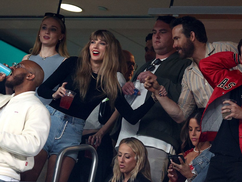 caption: Singer Taylor Swift and actor Ryan Reynolds are seen ahead of the game between the Kansas City Chiefs and the New York Jets at MetLife Stadium on Sunday in East Rutherford, N.J.