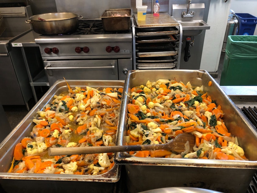 caption: Vegetable stir fry cooling in the kitchen. The food will be portioned and delivered to people in need. 