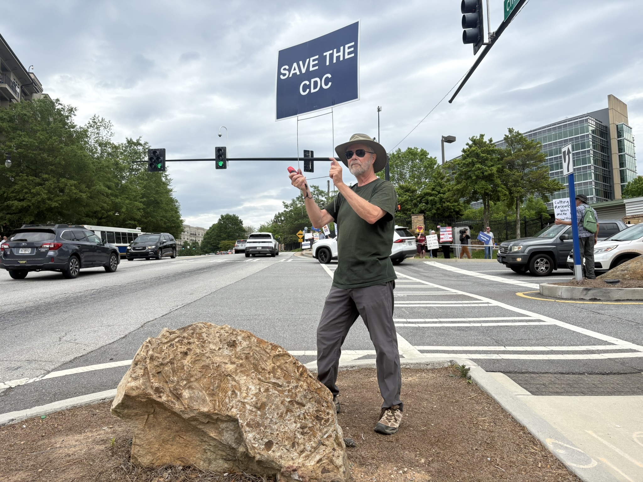 caption: Michael Beach, former deputy director of the Division of Foodborne, Waterborne and Environmental Diseases at CDC, attends a weekly protest outside the agency's main campus in Atlanta.