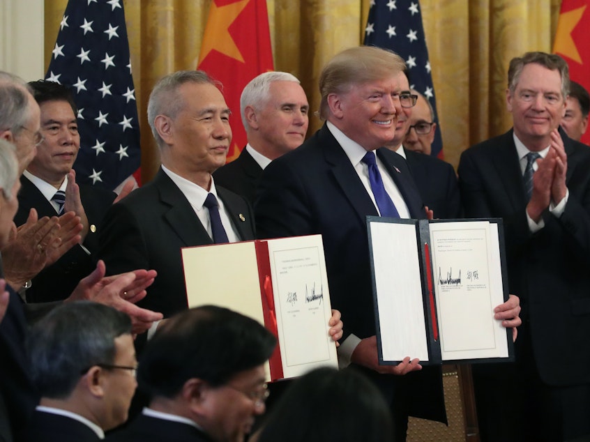 WASHINGTON, DC - JANUARY 15, 2020: Donald Trump and Chinese Vice Premier Liu He, hold up signed agreements of phase 1 of a trade deal between the U.S. and China, in the East Room at the White House.