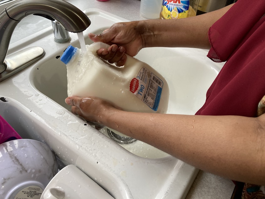 caption: The first time I saw my mom, Mulki Mohamed, wash the milk jug, I couldn’t believe what I was seeing. But she gave me a detailed explanation of why it’s important to wash the milk jug, as other people may have touched the milk with their own gloves. It’s now become a routine after buying milk.