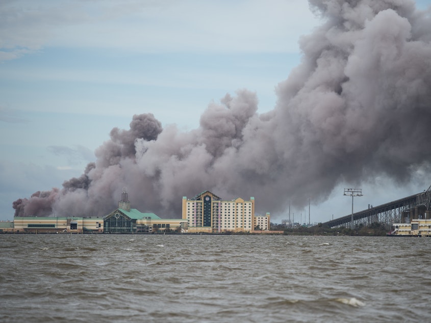 caption: A chemical plant near Lake Charles, La., burns after sustaining damage from Hurricane Laura in August 2020. A new analysis finds about one third of hazardous chemical facilities in the United States are at risk from climate-driven extreme weather.