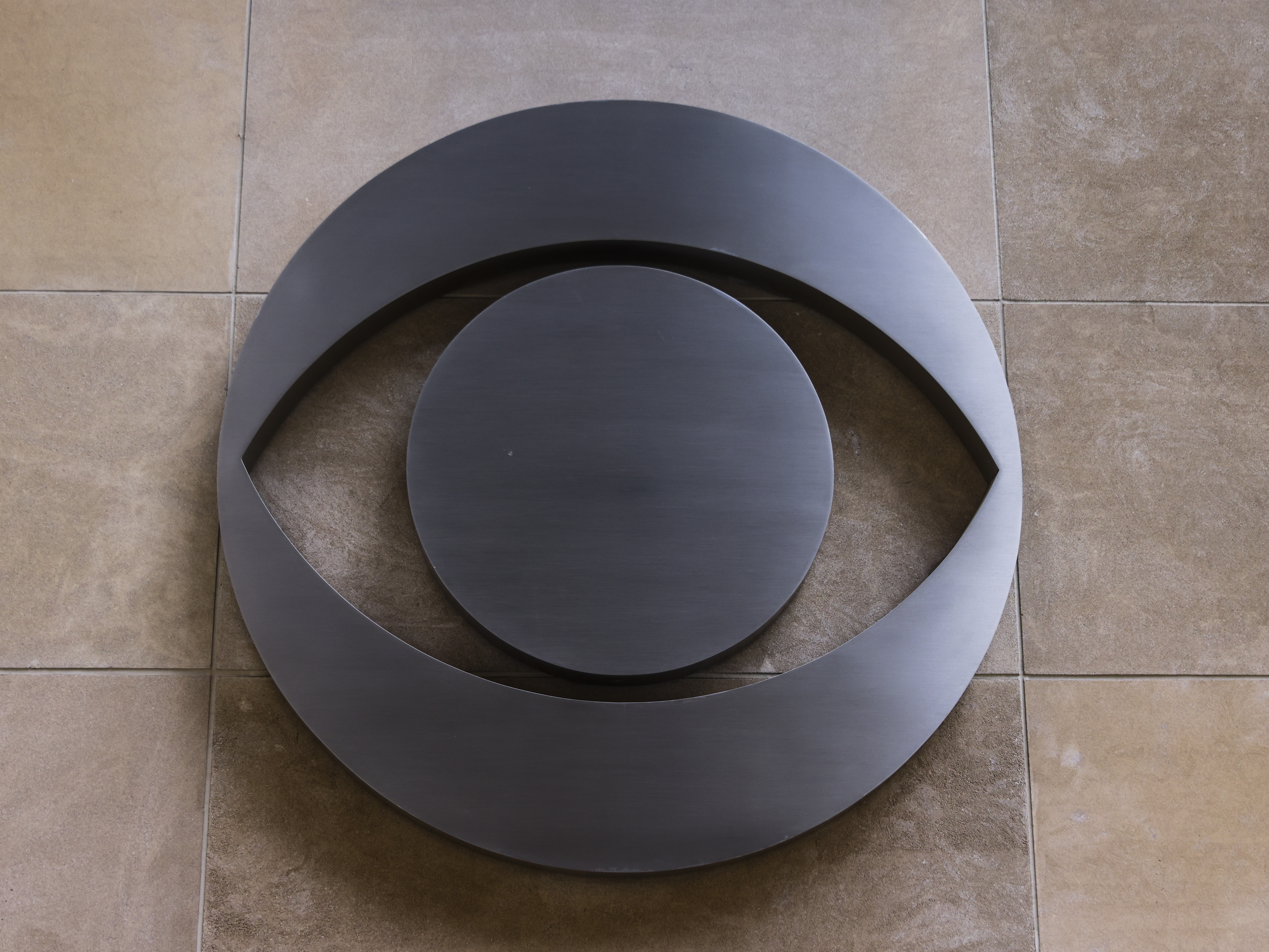 caption: The CBS logo is seen on a building in Chicago. The network's parent company, Paramount Global, has agreed to pay $16 million for President Trump's future presidential library to settle a lawsuit he filed over the editing of a <em>60 Minutes </em>interview with former Vice President Kamala Harris during last fall's elections.