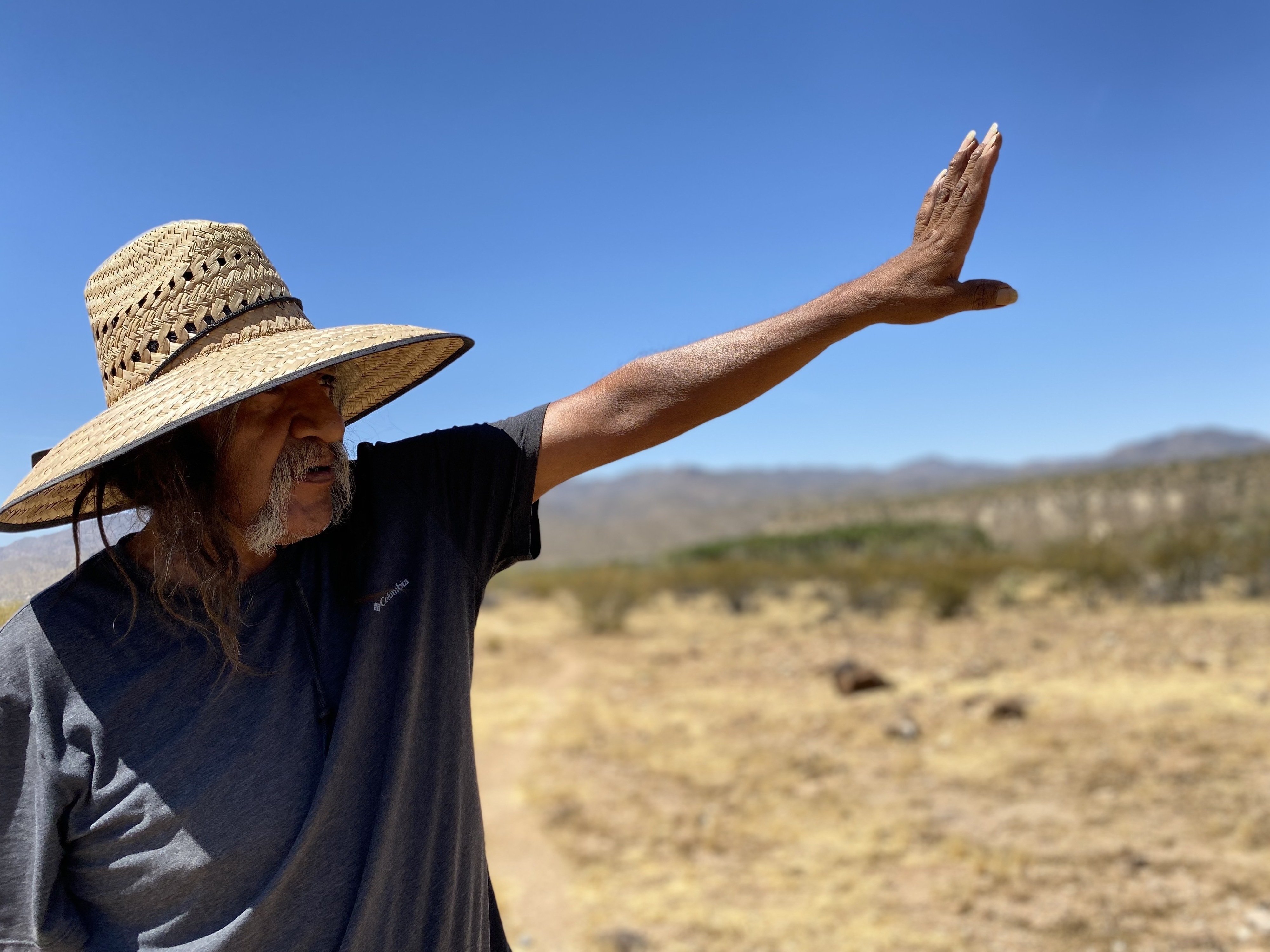 caption: In western Arizona, Ivan Bender, a Hualapai tribal member, points to an area, bordering Hualapai land, where an Australian mining company is exploring for lithium - a key metal in electric vehicle batteries.