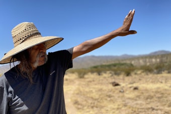 caption: In western Arizona, Ivan Bender, a Hualapai tribal member, points to an area, bordering Hualapai land, where an Australian mining company is exploring for lithium - a key metal in electric vehicle batteries.