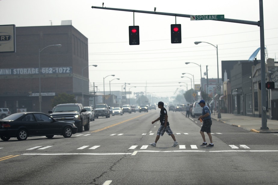 caption: Pedestrians cross a smoky North Wenatchee Avenue on Aug. 15, 2018, in Wenatchee. 