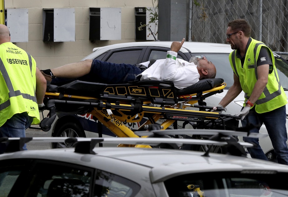 caption: Ambulance staff take a man from outside a mosque in central Christchurch, New Zealand on Friday. Multiple people are in custody after shootings at two mosques there.