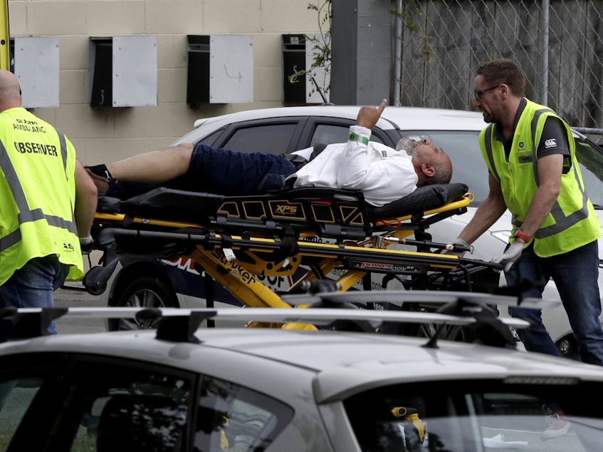 caption: Ambulance staff take a man from outside a mosque in central Christchurch, New Zealand on Friday. Multiple people are in custody after shootings at two mosques there.