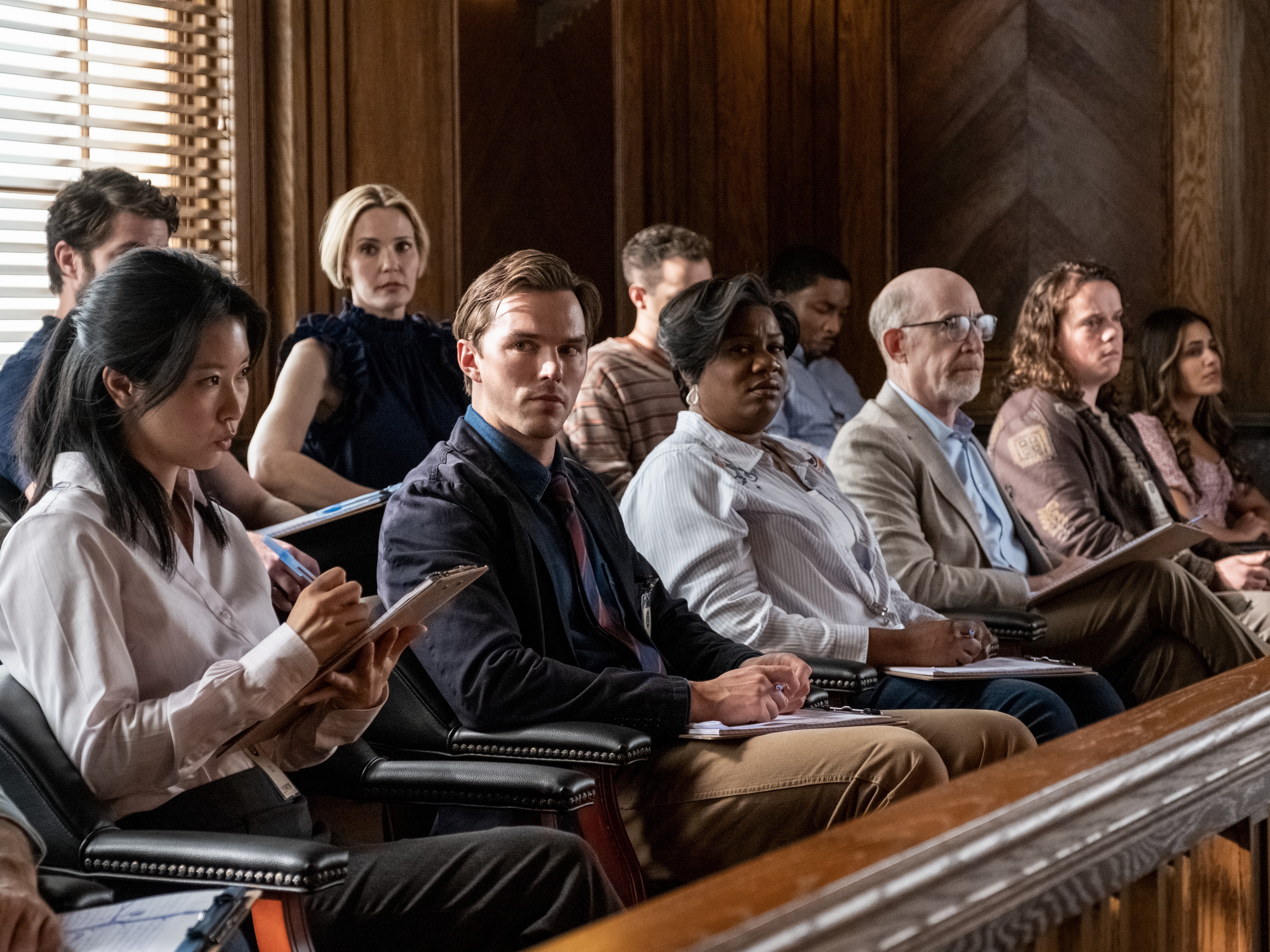 caption: Nicholas Hoult (front row, center) plays Justin Kemp in<em> Juror #2.</em>
