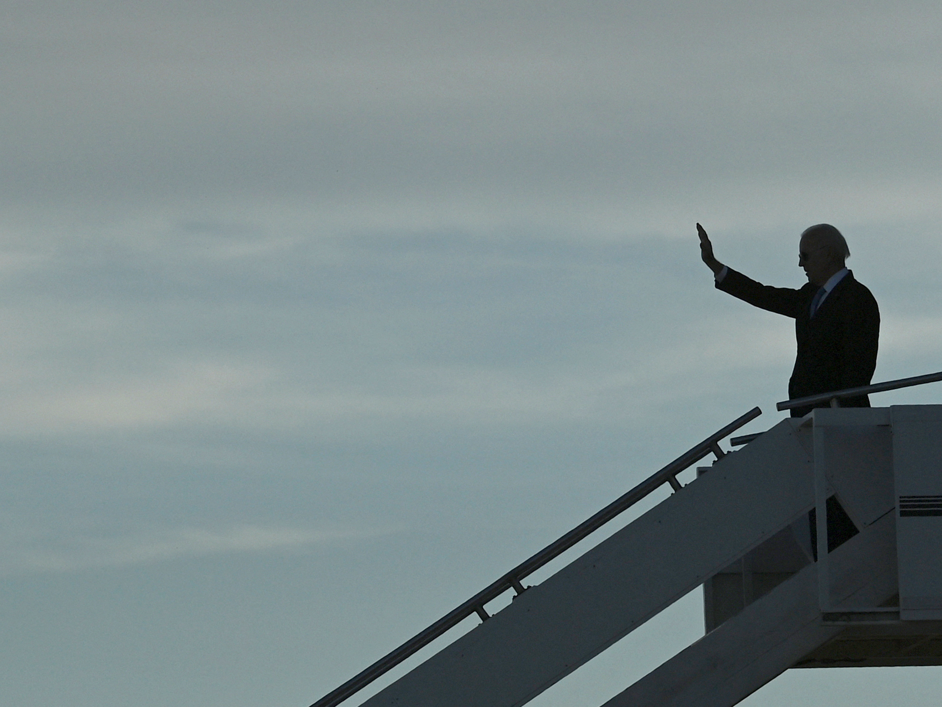 caption: President Biden waves as he prepares to depart the airport after meeting with Russian President Vladimir Putin in Geneva, on June 16.