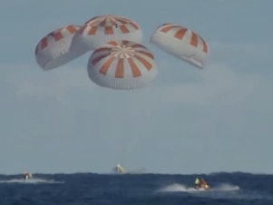 caption: The Crew Dragon landed safely in the Atlantic Ocean on Friday morning, with a splashdown at 8:45 a.m. ET, as scheduled. The uncrewed craft had been on a test flight in which it docked with the International Space Station.